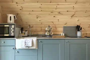 Glamping pod kitchen with a hob, microwave, toaster, sink and fridge/freezer