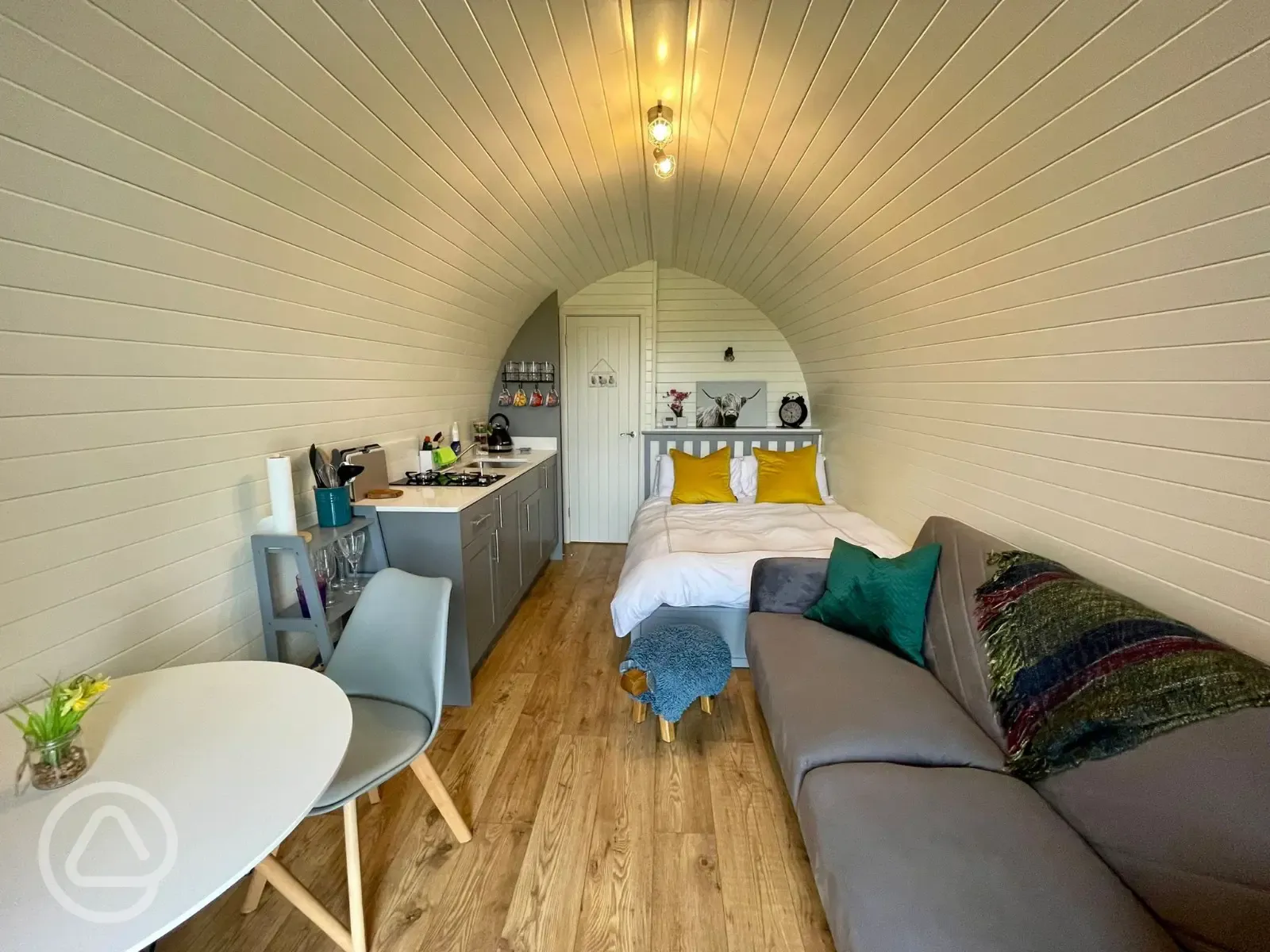 Luxury ensuite glamping pod with a double bed, dining space, sofa, and kitchen Luxury ensuite glamping pod with a double bed, dining space, sofa, and kitchen