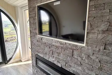 Usk glamping pod living area TV and fireplace Usk glamping pod living area TV and fireplace