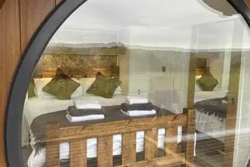 Eight person (Severn) pod king size bedroom with a large window Eight person (Severn) pod king size bedroom with a large window