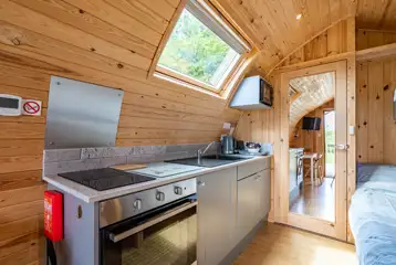 Kitchen with a microwave, oven, sink, kettle and toaster