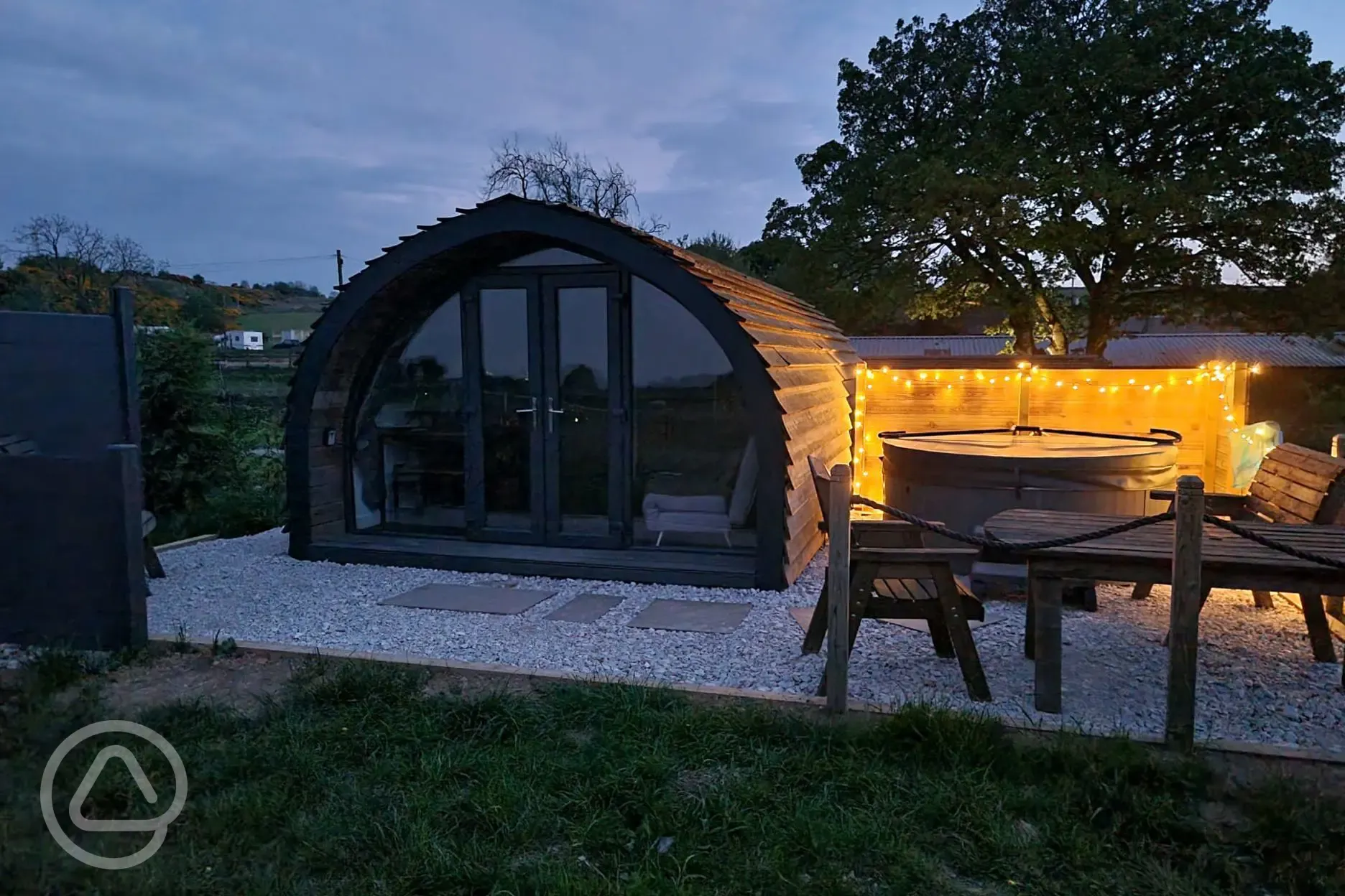 Robin glamping pod and hot tub at night
