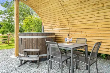 Wood fired hot tub and dining table of the ensuite glamping pod at Church House Wood fired hot tub and dining table of the ensuite glamping pod at Church House