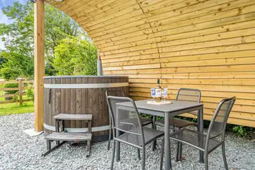 Wood fired hot tub and dining table of the ensuite glamping pod at Church House