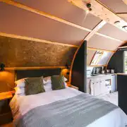 Quarry pod interior with double bed and kitchenette Quarry pod interior with double bed and kitchenette