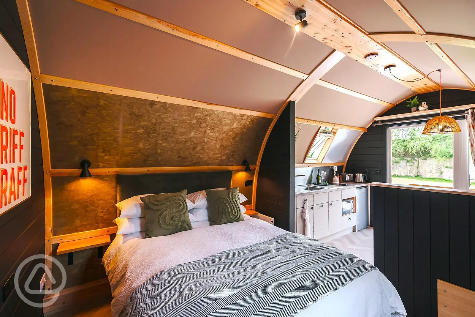 Quarry pod interior with double bed and kitchenette Quarry pod interior with double bed and kitchenette