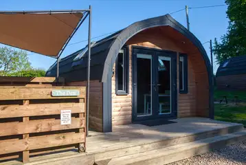 The Den glamping pod with a covered hot tub and decking The Den glamping pod with a covered hot tub and decking