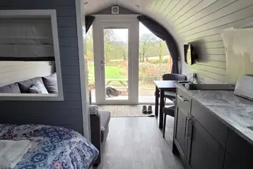 The Nest glamping pod interior with countryside views The Nest glamping pod interior with countryside views