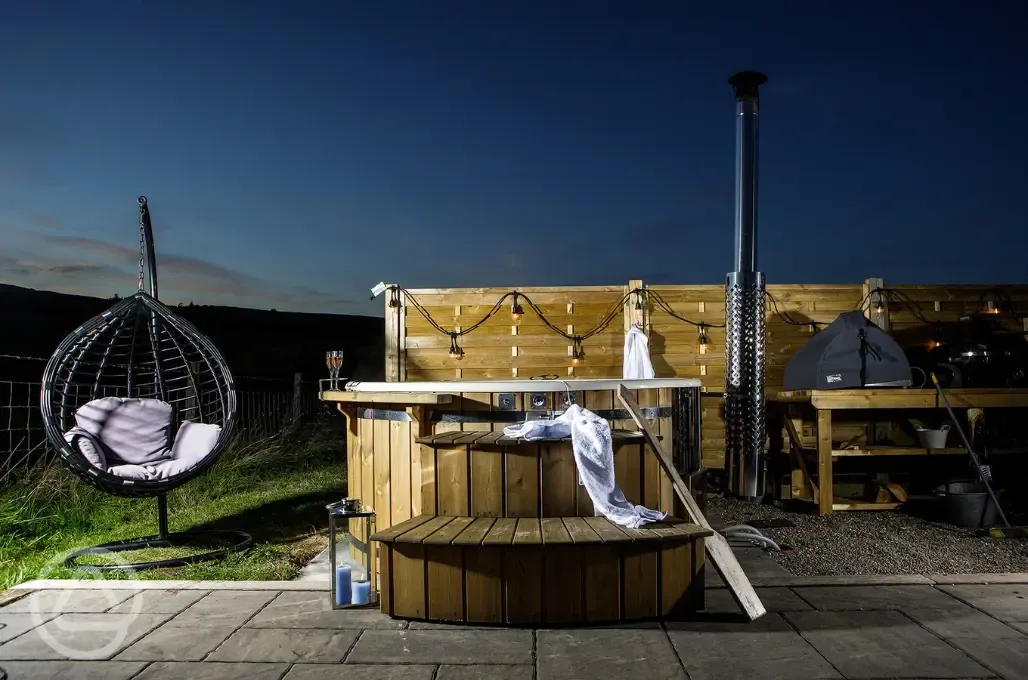 White Clover ensuite pod wood-fired hot tub with fairy lights at night White Clover ensuite pod wood-fired hot tub with fairy lights at night