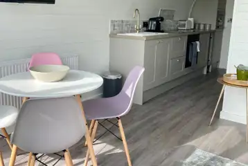 White Clover ensuite pod dining area with a fully-equipped kitchen White Clover ensuite pod dining area with a fully-equipped kitchen