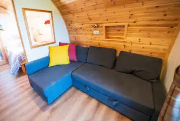 Ensuite glamping pod sofa bed and living area Ensuite glamping pod sofa bed and living area