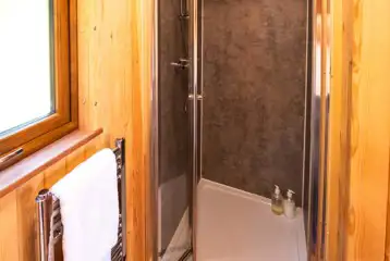 Ensuite glamping pod bathroom with toilet, sink, shower and heated towel rail Ensuite glamping pod bathroom with toilet, sink, shower and heated towel rail