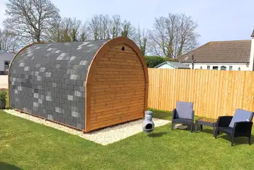 Camping pod with an outdoor seating area and chimenea