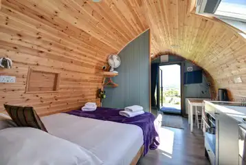 View from the back of the pods with a king size bed and TV View from the back of the pods with a king size bed and TV