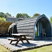 Pen-y-ghent glamping pod with a picnic bench and covered outdoor area