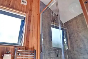 Ensuite with a flushing toilet, shower, hand basin and a heated towel rail Ensuite with a flushing toilet, shower, hand basin and a heated towel rail