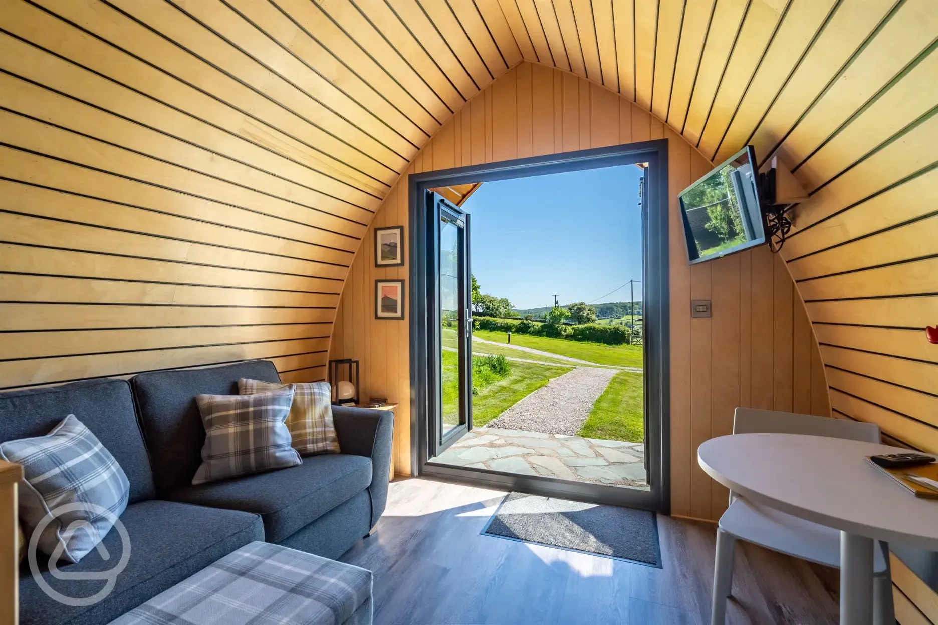 Glamping pod sofa, TV and dining area