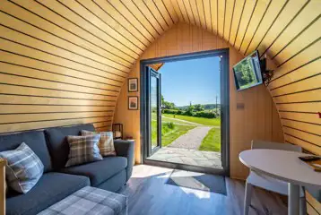 Glamping pod sofa, TV and dining area Glamping pod sofa, TV and dining area