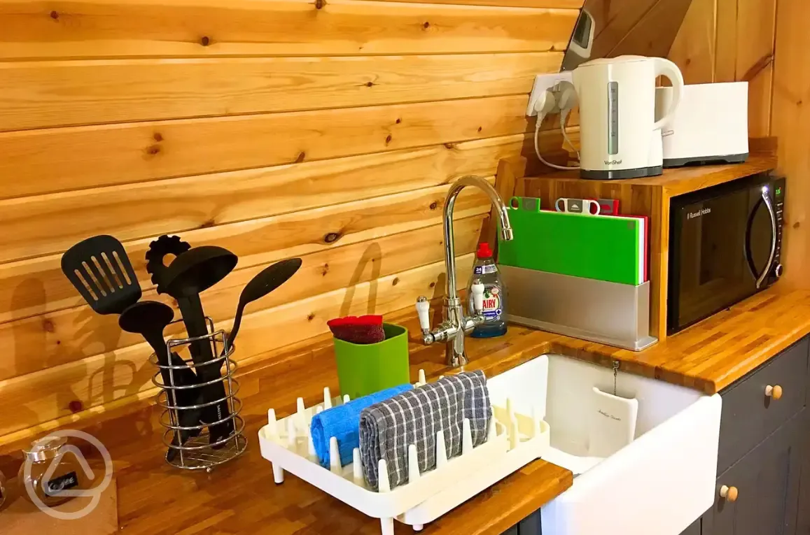 Pod kitchenette with sink, microwave, utensils, toaster and kettle Pod kitchenette with sink, microwave, utensils, toaster and kettle