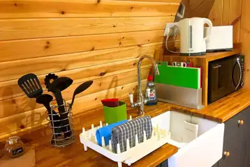 Pod kitchenette with sink, microwave, utensils, toaster and kettle Pod kitchenette with sink, microwave, utensils, toaster and kettle