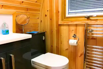 Pod ensuite with toilet, shower, sink, mirror and radiator Pod ensuite with toilet, shower, sink, mirror and radiator