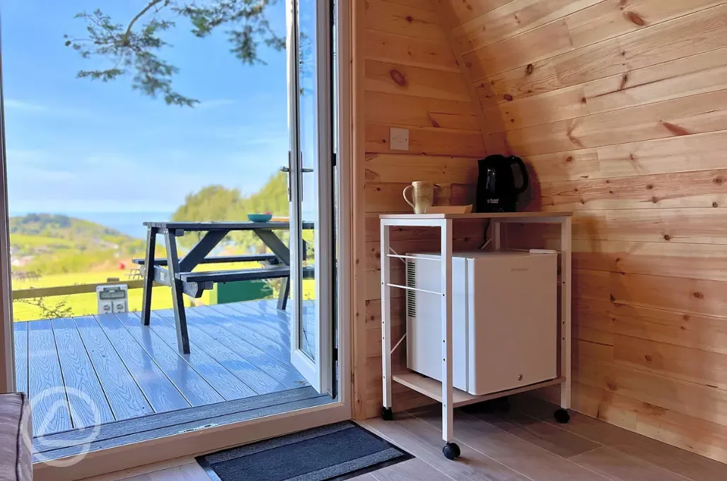 Camping pod with sea views with a fridge, kettle, and outdoor seating