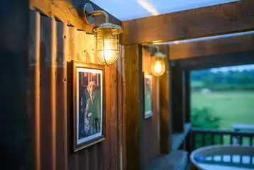 Outdoor sheltered electric hot tub with furnishings and lights