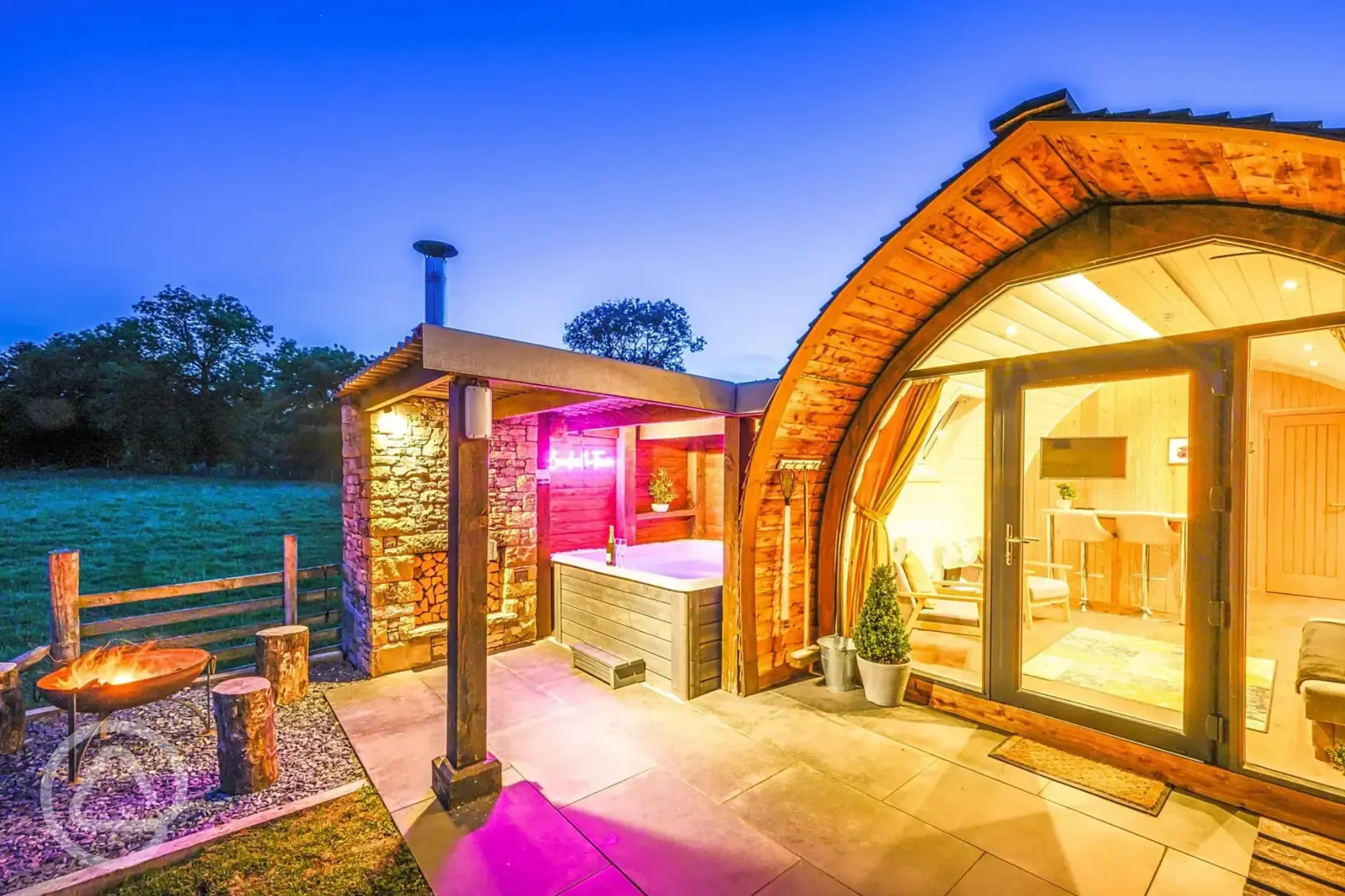  Enterber ensuite glamping pod lit up at night 
