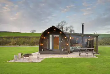 Exterior of the glamping pods with fire pits, hot tubs, and private patios Exterior of the glamping pods with fire pits, hot tubs, and private patios