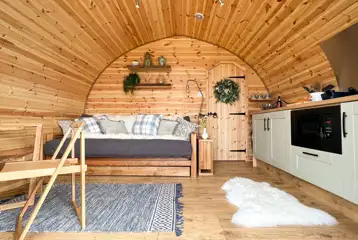 Chaplin's Club pod living area and kitchen area with a double sofa bed Chaplin's Club pod living area and kitchen area with a double sofa bed