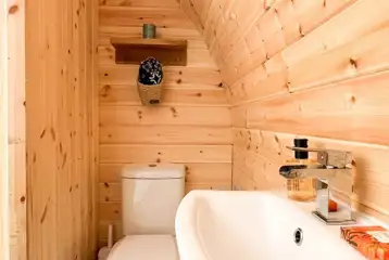 Chaplin's Club pod ensuite with a toilet, shower, hand basin, towels and robes Chaplin's Club pod ensuite with a toilet, shower, hand basin, towels and robes