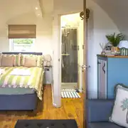 Paddywack interior with a double bed, sofa bed and ensuite bathroom