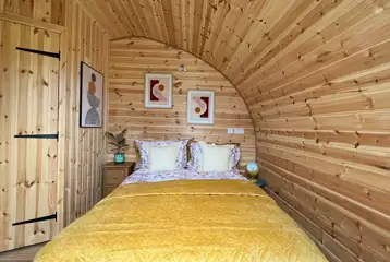 Glencroft pod separate double bedroom with a TV and door to the deck area Glencroft pod separate double bedroom with a TV and door to the deck area