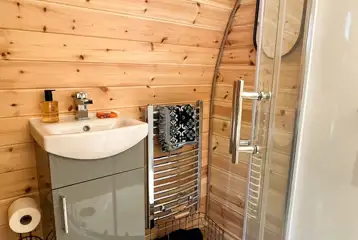 Chaplin's Club pod ensuite with a toilet, shower, hand basin, towels and robes Chaplin's Club pod ensuite with a toilet, shower, hand basin, towels and robes