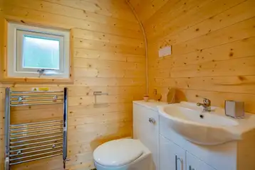 Glamping pod ensuite toilet with a heated towel rail Glamping pod ensuite toilet with a heated towel rail