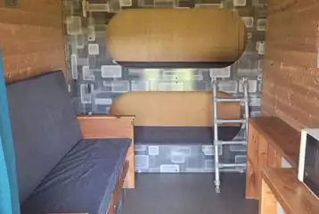 Bunk bed glamping pod interior with two bunk beds and two fold out beds Bunk bed glamping pod interior with two bunk beds and two fold out beds