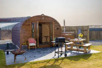 Carrock Sunset Glamping Pod featuring a fire pit, BBQ, and picnic bench