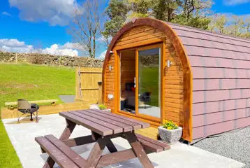 Carrock Squirrel Glamping Pod with outdoor picnic bench