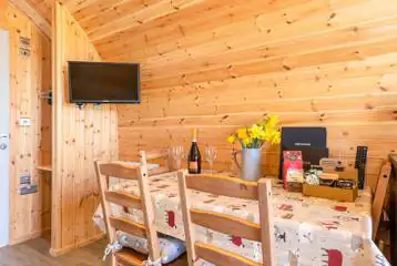 Glamping pod dining area with table, four chairs and tv Glamping pod dining area with table, four chairs and tv