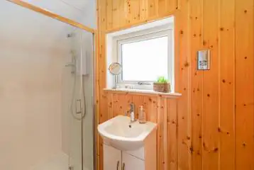 Glamping pod ensuite with toilet, shower, sink and mirror Glamping pod ensuite with toilet, shower, sink and mirror