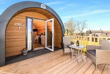 Bluebell glamping pod exterior with private decking area and outdoor seating Bluebell glamping pod exterior with private decking area and outdoor seating