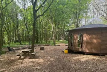 Roundhouse wooden yurt with a picnic bench