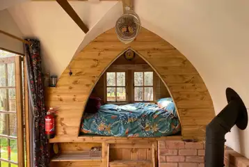 Glamping shepherd's hut interior with a double bed