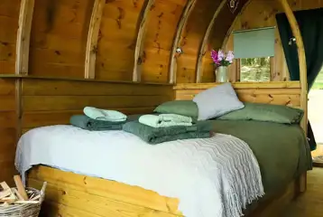 Glamping pod interior with double bed