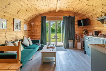 Ensuite glamping pod living area with TV