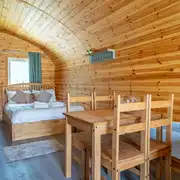 Ensuite glamping pod double bed and dining area