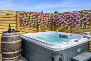 Private electric hot tub with a flower wall