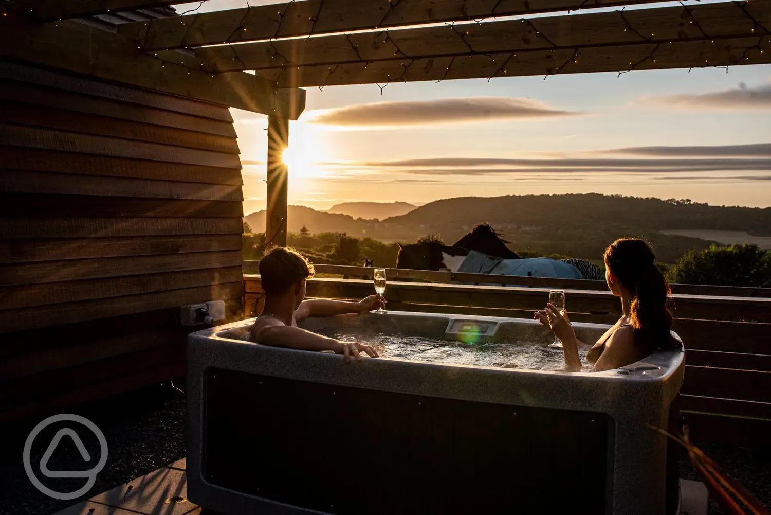 Glamping pod hot tub at sunset