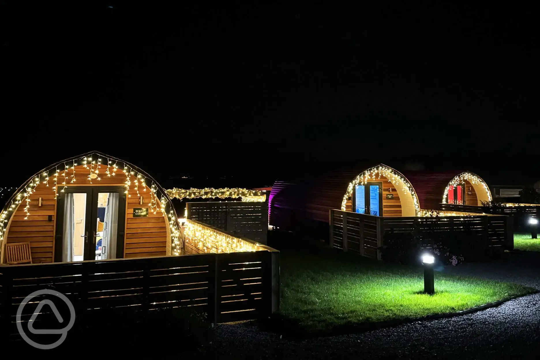 Ensuite glamping pods with hot tubs at night