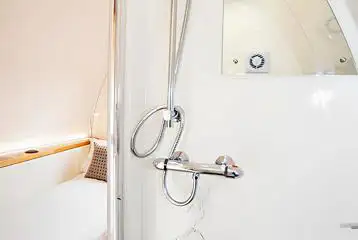 Glamping pod ensuite with a toilet, shower, and handwashing sink